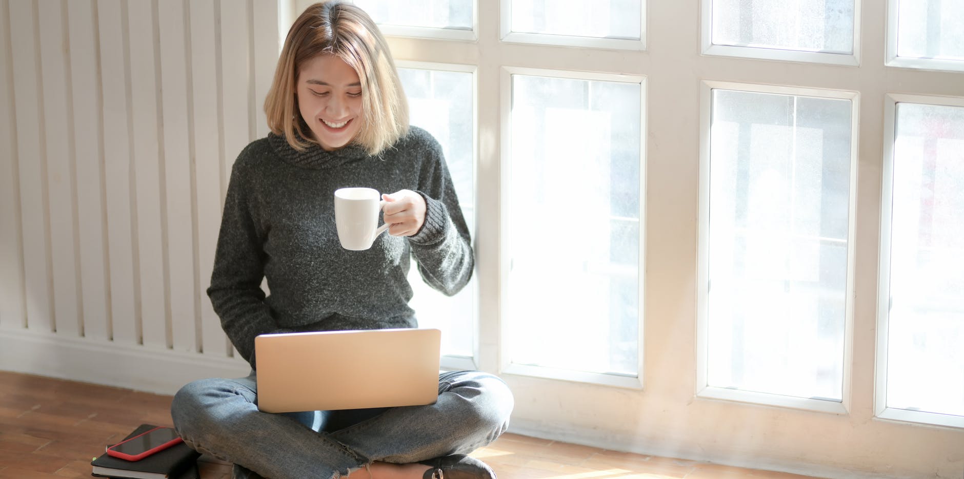 woman-sitting-on-floor-working-laptop